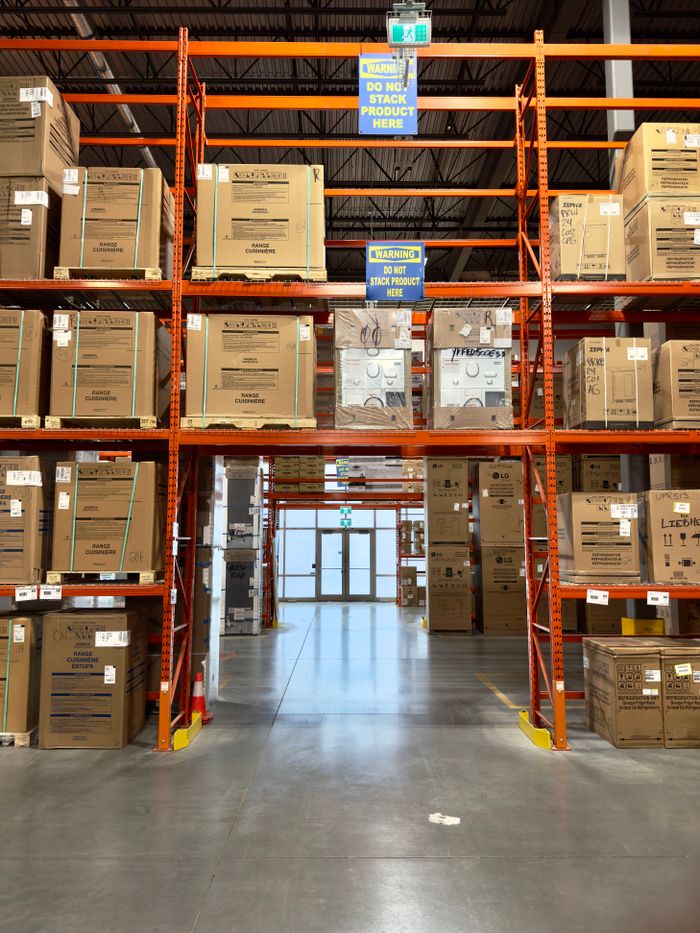 The Art of Drawing Readers In: Your attractive post title goes here Large warehouse interior with racks filled with cardboard boxes, offering ample storage space.
